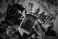 pexels-photo-31415467-31415467 Collection of vintage photos with a retro camera, evoking nostalgia and memories.