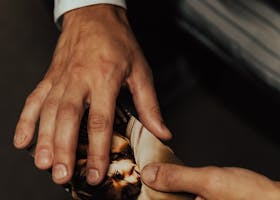 A close-up shot of two hands exchanging a photograph, concept of memory and relationships.